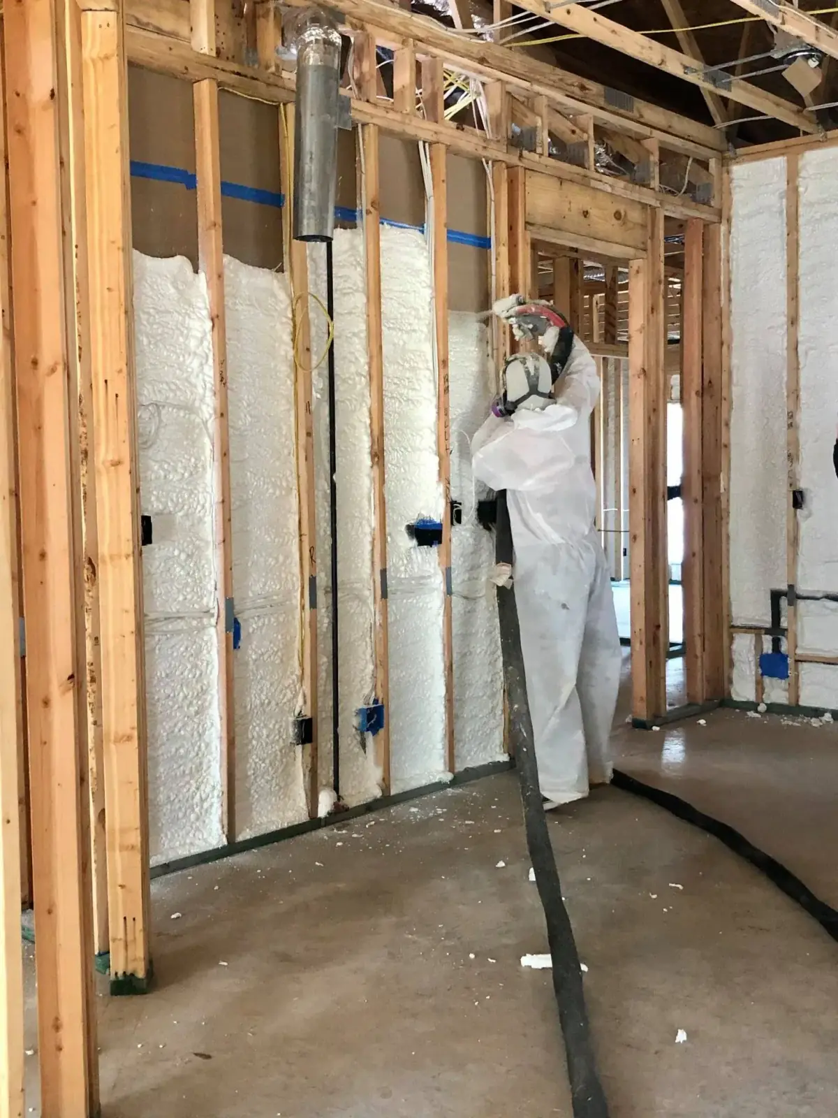Closed-cell spray foam insulation applied to a wall cavity by Ozark Eco Foam